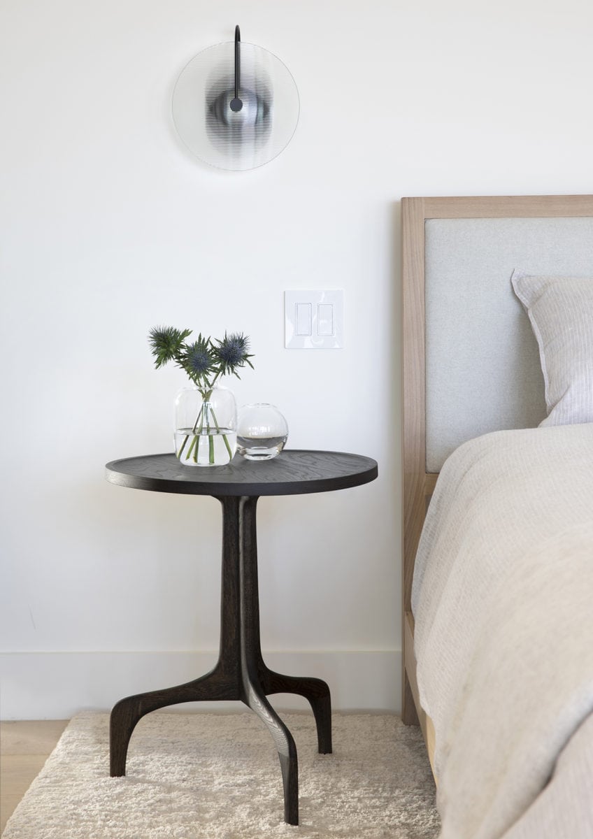 Sculptural bedside table and modern sconce